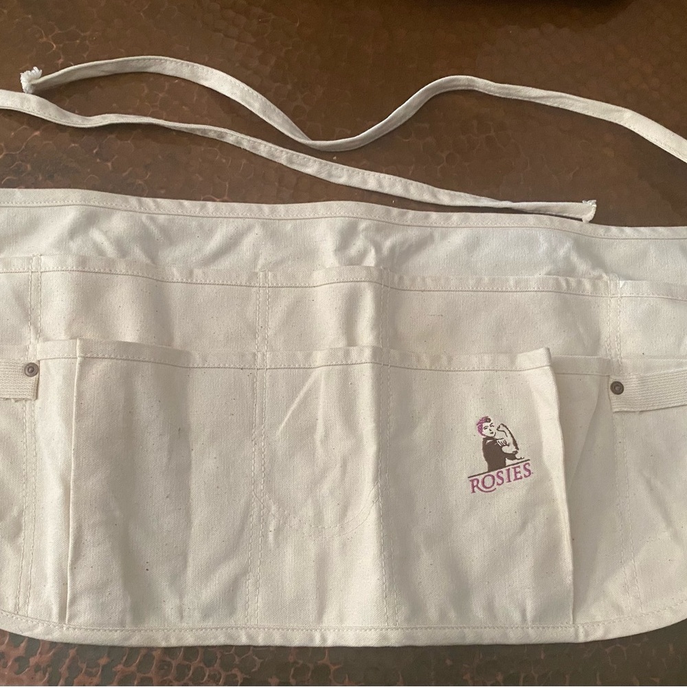 Heavy duty canvas and riveted gardening or tool waist pouch.
